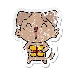 distressed sticker of a happy little cartoon dog with present