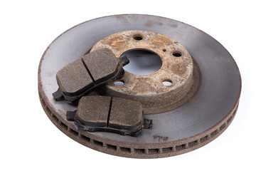 Brake pads and brake discs on white background