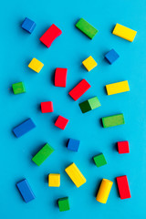 Fototapeta na wymiar Children background. Wooden building blocks for developing and entertainment on blue background top view