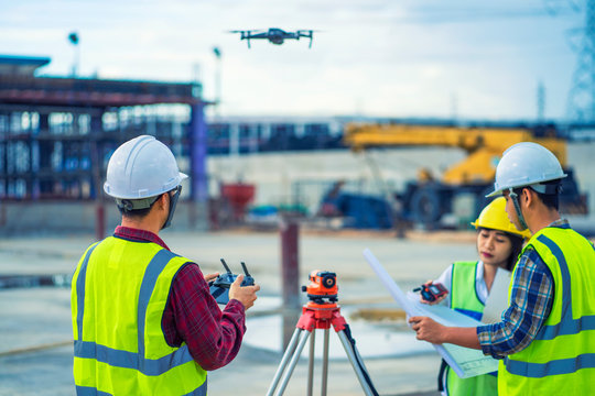 civil engineering flying drone over construction site survey for land and building project.