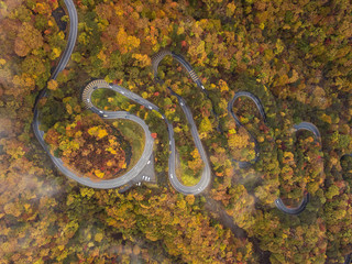 Aerial of narrow and winding street (2nd Irohazaka route) in foliage starts changing color, Hosoomachi, Nikko, Tochigi.