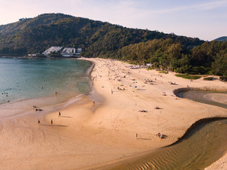 Aerial view of tourism sunbathe, swiming and playing games on the beach (HAT NAI HAN) at sunset, Phuket, Thailand