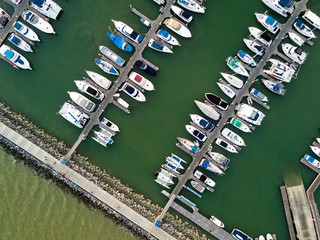 Fototapeta na wymiar Aerial view of anchored luxury yacht and catamaran in marina (Photo from drone)