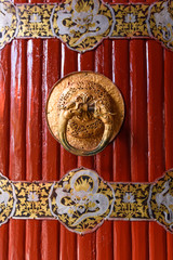 Dual-dragon round shape metal door knocker on the door of the former 