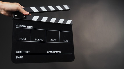 Fototapeta na wymiar Hand's holding Clapperboard or movie slate use in video production ,film, cinema industry on black background.
