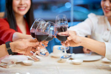 People toasting with wine glasses