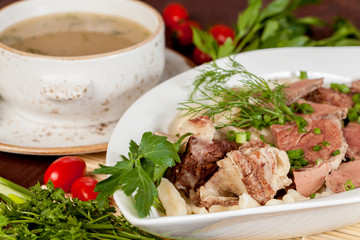  an appetizing meat dish with soup, beautifully laid out with vegetables, for use in design