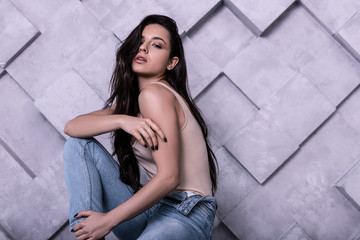 Waist-up photo of posing pretty supermodel with slightly raised head