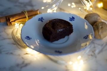 Brownie on plate with lights and spides