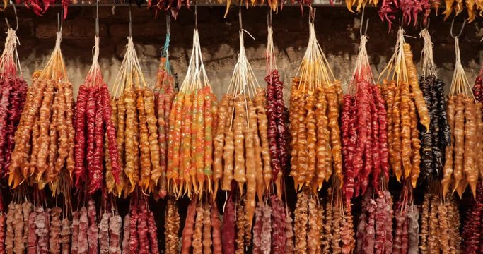 Colorful Churchkhela Hanging In Shop. Churchkhela Is A Traditional Georgian Food Sausage-shaped Candy. Main Ingredients Are Grape Must, Nuts And Flour