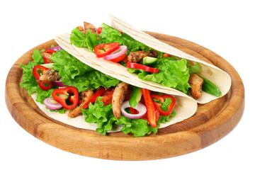 Tortilla wrap with fried chicken meat and vegetables on wooden board isolated on white background
