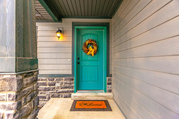 Entryway with wreath and doormat on the front door
