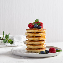 Stack of Homemade pancakes with berries and honey. Breakfast concept.