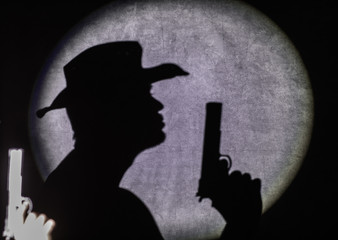 shadow of a man with a gun