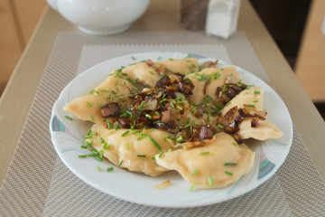 traditional Russian dish dumplings with potatoes bacon and fried onions