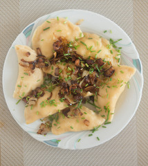 traditional Russian dish dumplings with potatoes bacon and fried onions