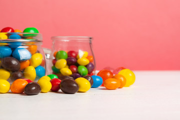 Bottles with sweet candies on table