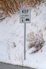 Keep Left and Keep Right sign against snowy slope