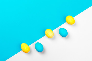 Candy color easter eggs over bright paper background