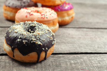 Glazed donuts on wooden background