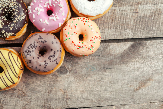 Glazed donuts on wooden background
