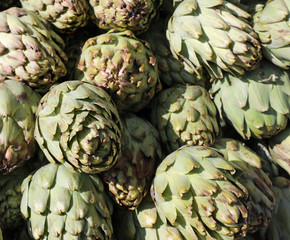 background of green ripe artichokes in the supermarket fruit and
