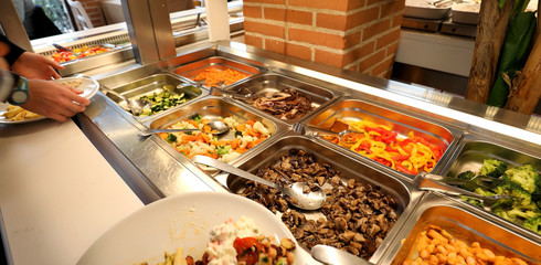 self service restaurant with many raw and cooked foods