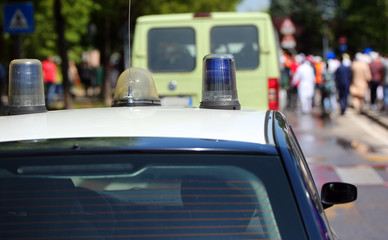 car of police with sirens in the city