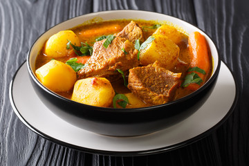Traditional African slow lamb stew with vegetables and spices close-up in a bowl. horizontal