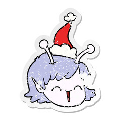distressed sticker cartoon of a alien space girl face wearing santa hat