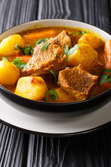 Potjiekos is one of the most authentic South African dishes from lamb and vegetables close-up in a bowl. vertical