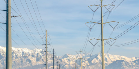 Power lines against Mount Timpanogos and blue sky