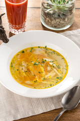 vegetarian cabbage soup with celery on white plate on textile napkin