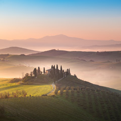 A lonely farmhouse between tuscan rolling hills. Val d'Orcia, Siena province, Tuscany, Italy