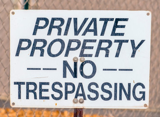 Private Property No Trespassing sign on a fence
