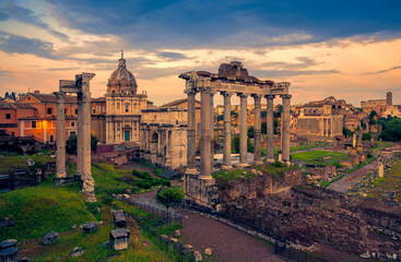 Naklejka na ściany i meble View of the temple of Saturn in Roman forum, Italy. Ruins of Septimius Severus Arch and Saturn Temple. Rainbow over the Roman forum. Rome architecture and landmark.