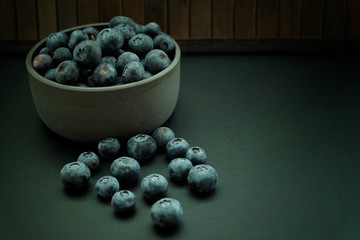 Blueberries on black plate and black background. 