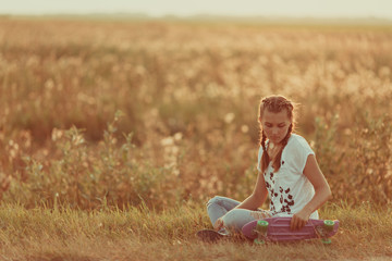 Young happy cute girl rides skateboard on road, outdoor