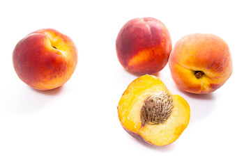 Naklejka na ściany i meble Group of ripe peach fruit and a half isolated on white background.