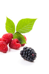 Ripe raspberries with leaf and blackberry isolated on white background.