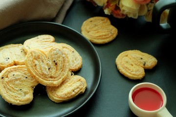 Butterfly cookies on black plate and black background. 