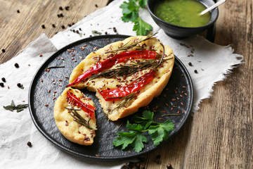 Plate with tasty Italian focaccia on wooden table