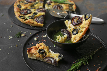 Tasty Italian focaccia with basil sauce on table