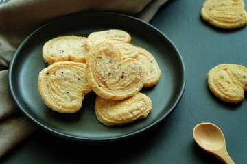 Butterfly cookies on black plate and black background. 