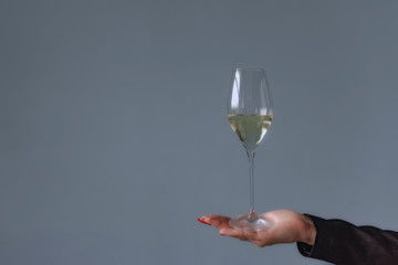 Woman holding a wine glass with wine in hand. Copy space
