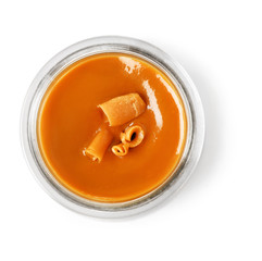 Jar with sweet liquid caramel on white background