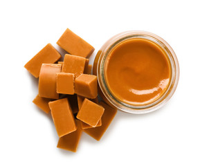 Jar with sweet liquid caramel on white background