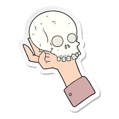 sticker of a cartoon hand holding skull