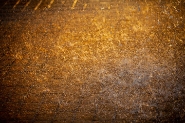 Splashes of water and bokeh of Water on a Sunset Background.