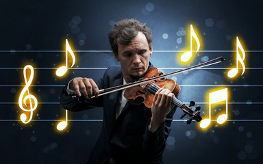 Fototapeta premium Young handsome fiddler playing with music sheet background